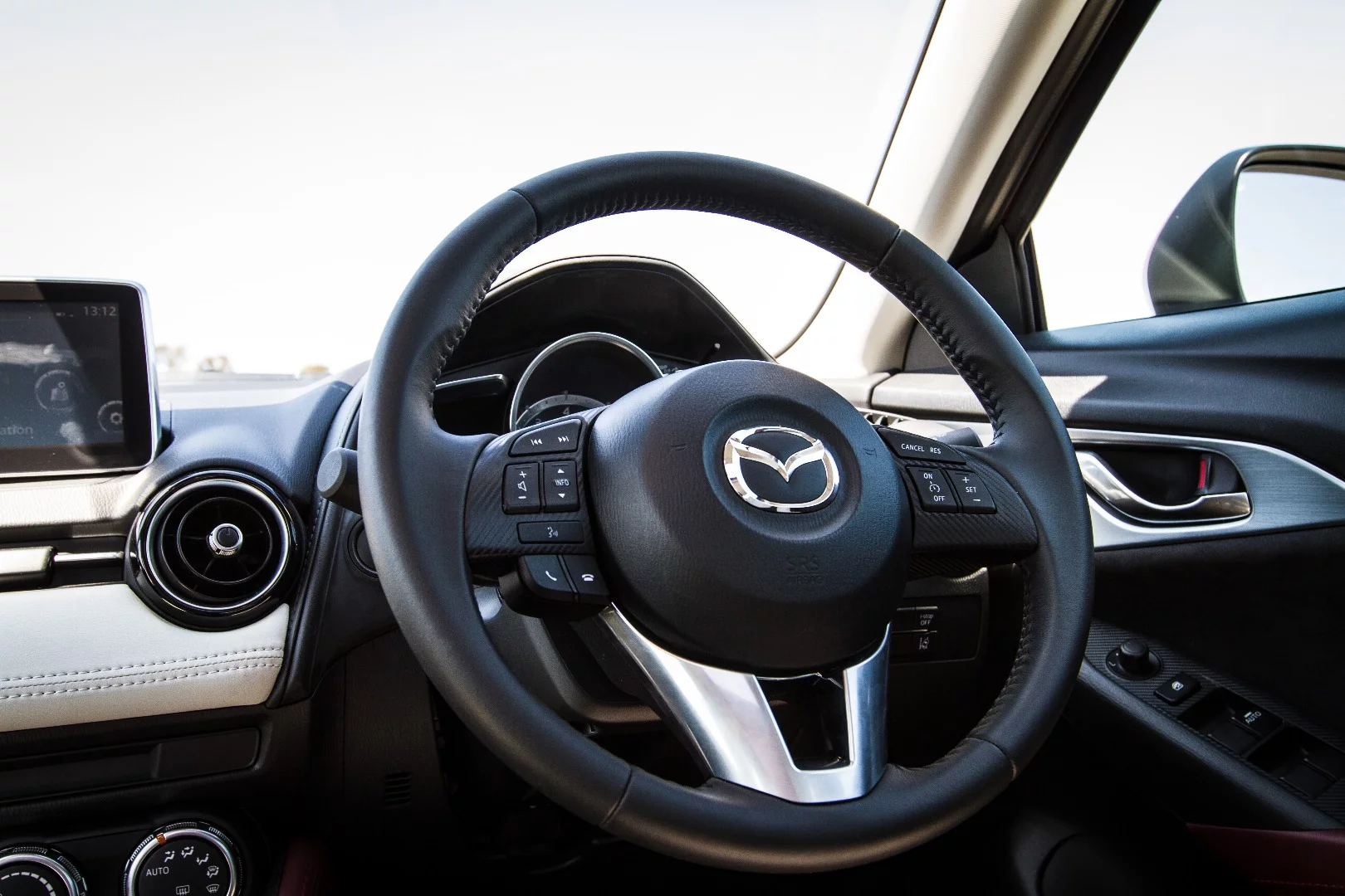 The Mazda's chubby little steering wheel feels like a quality item