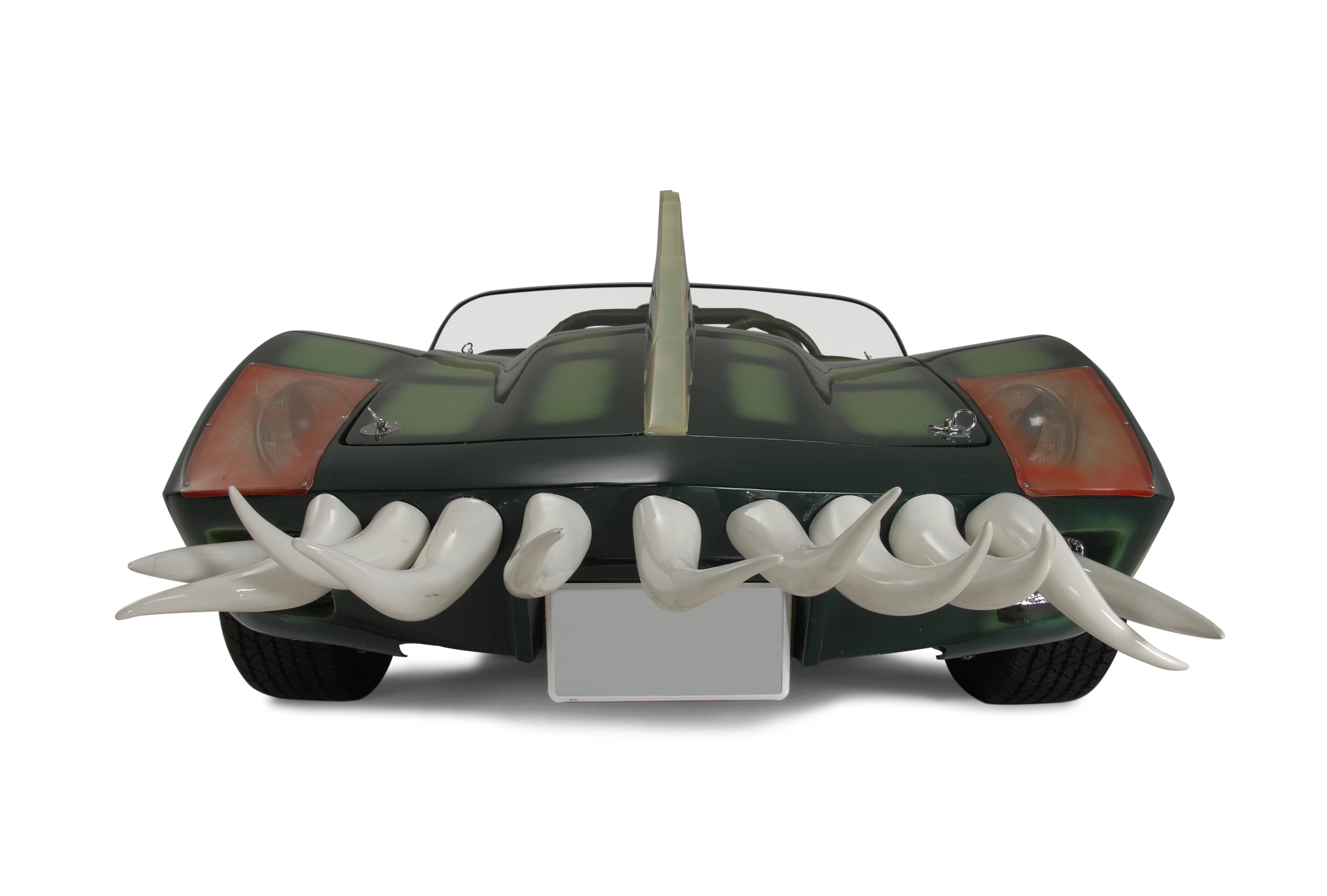 The car that is coming to auction is the Alligator Corvette driven by Carradine in Death Race 2000 (1975). The one-of-a-kind “alligator” Corvette (it's actually a Volkswagen chassis with an air-cooled Corvair motor), is expected to fetch between $20,000 and $25,000, despite the fact it got lots of screen time as Carradine (Frankenstein) fights against his deadly rival Stallone (Machine Gun Joe).