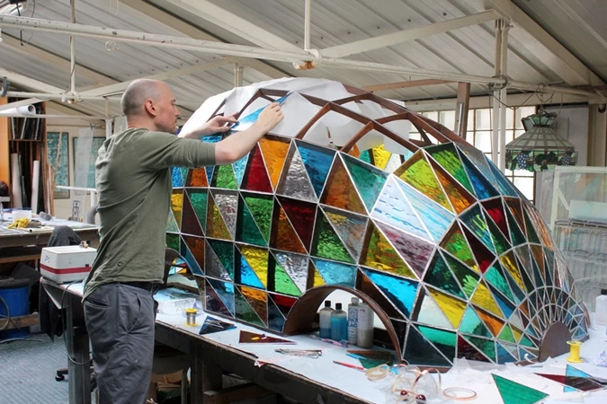 Glass is fitted into the frame of the Stained Glass Driverless Sleeper Car (Image: Sylvain Deleu)