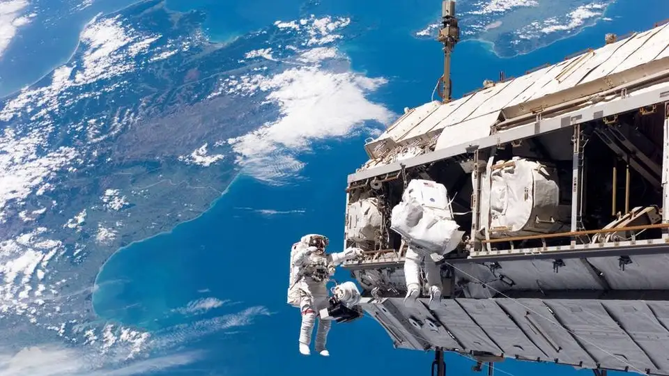 Astronauts toiling away on the International Space Station during an earlier spacewalk