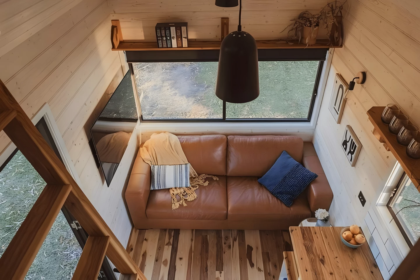 The Gunyah's living room includes a sofa and a wall-mounted TV