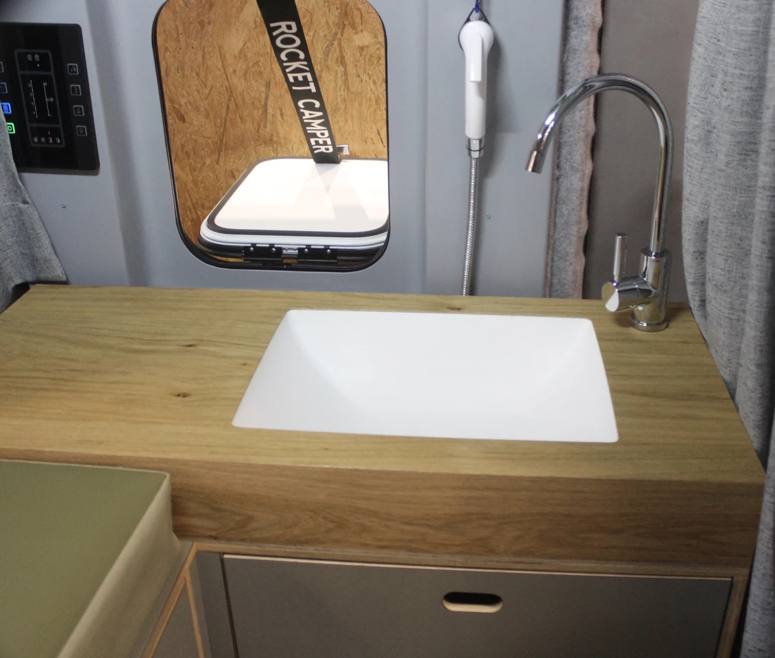 Perhaps the most interesting part of the build, the deconstructed bathroom combines a sink, slide-out portable toilet, outdoor shower and personal organizer