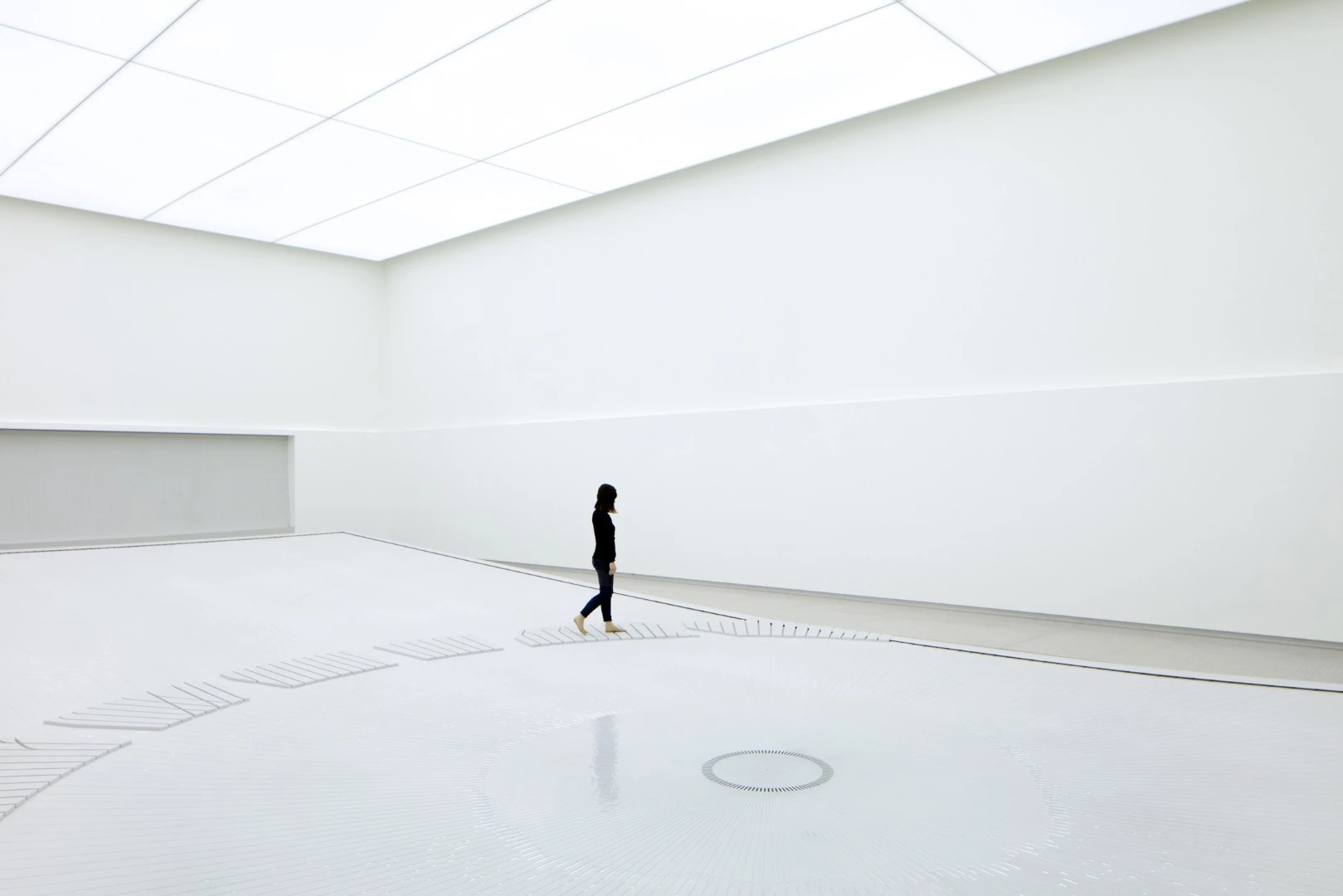 The water installation inside uses water droplets to create a visage resembling the sight of a giant city from space