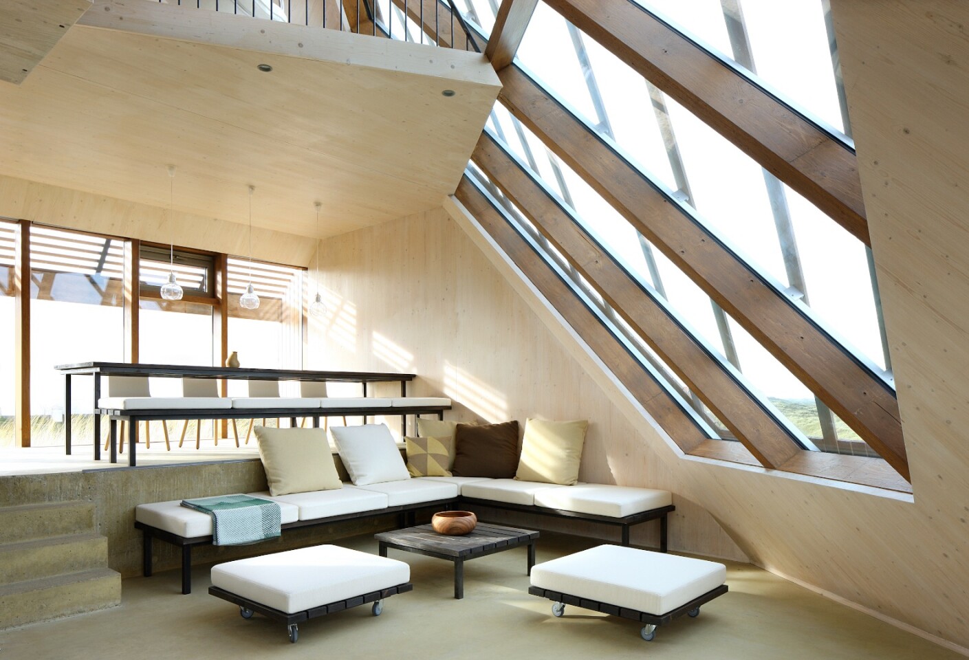The lounge areas are separated by staggered half-floors, accessed by stairs (Photo: Filip Dujardin)