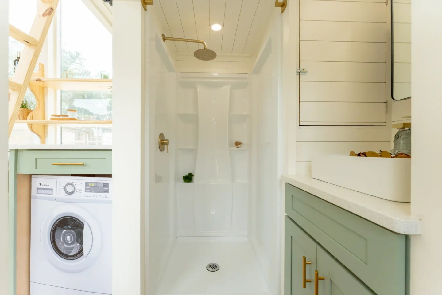The custom Vista's bathroom has a walk-in shower, a small vanity sink, and a flushing toilet