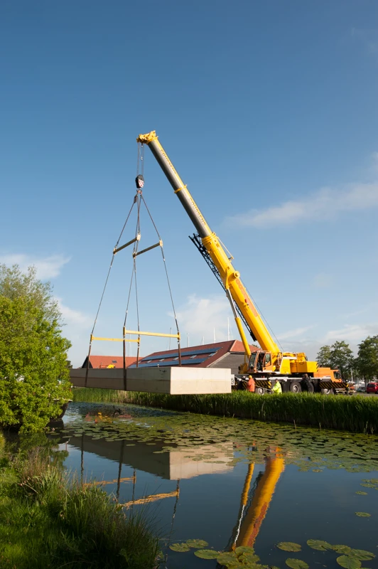 The hull of the Chichester floating home is craned into position