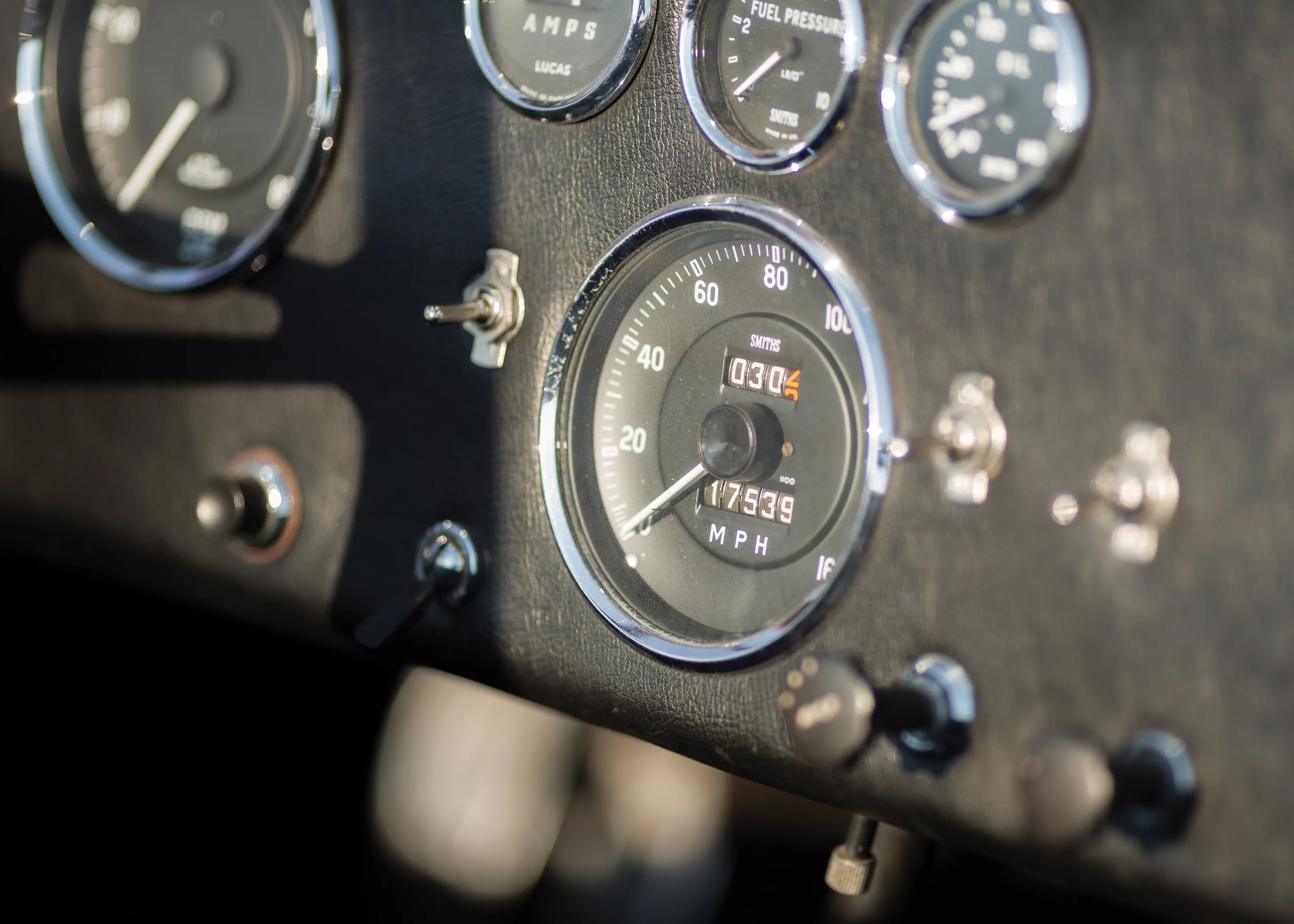 While much has been written about this Cobra, it is most famous for its appearances in promotional pieces for the menswear company, Mr. Formal Wear, the most famous of which depicts a buxom blonde, clad in white tuxedo shirt, bow tie, high heels, and nothing else, chatting on a payphone next to the Cobra before two astonished onlookers. Another piece, famously titled “Some Guys Have It Tough,” depicts the Cobra beachside, with its driver and his lovely passenger skinny-dipping in the distance. Those posters appeared on bedroom and workshop walls all over the country and became legend among Cobra enthusiasts. This is THAT car. It sold for $990,000.