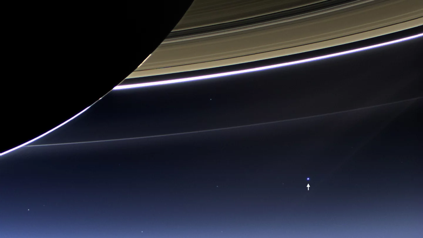 A blue Earth shines beneath Saturn's rings in this 2013 Cassini image