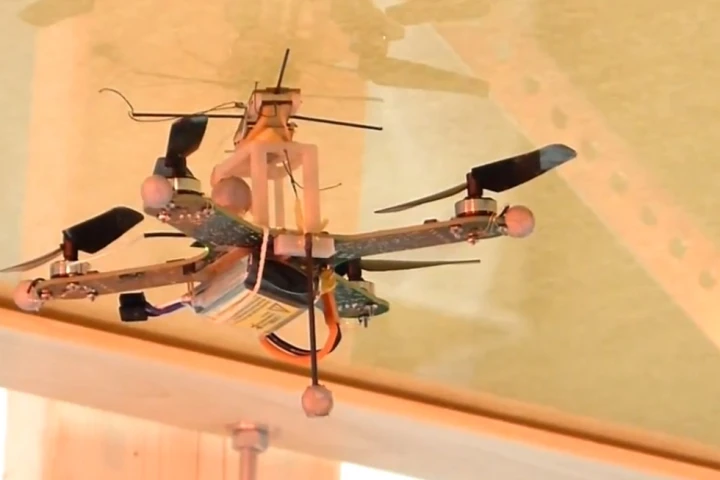 Researchers have developed a quadcopter that can attach to walls and ceilings with a dry adhesive before taking off again