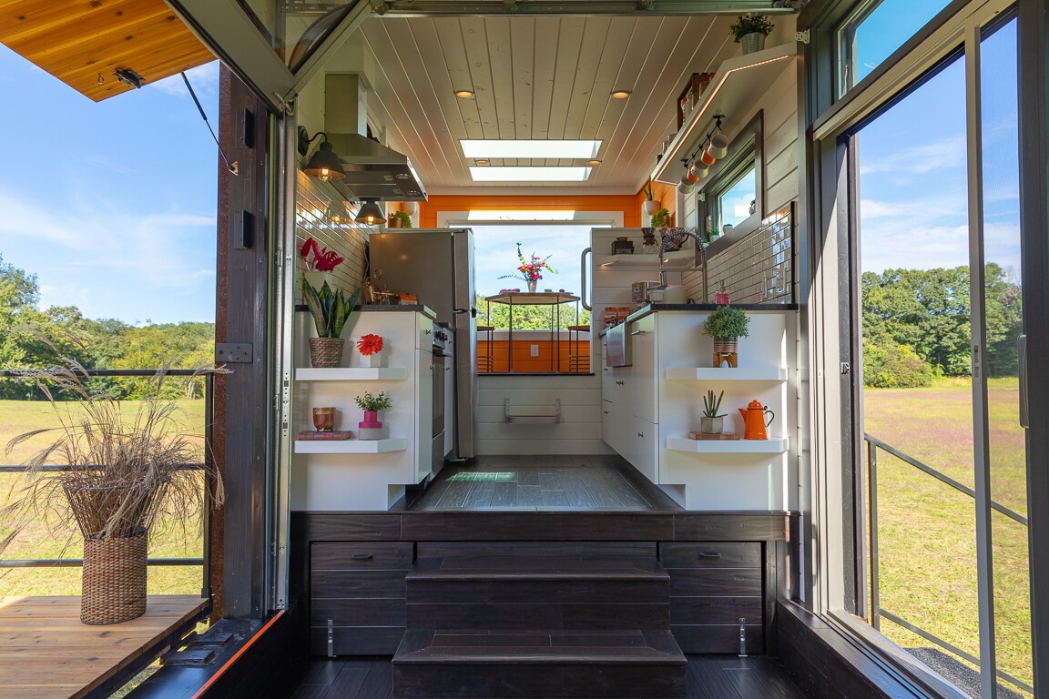 The Home That Runs on Dunkin' opens up to the porch area with garage-style lifting door