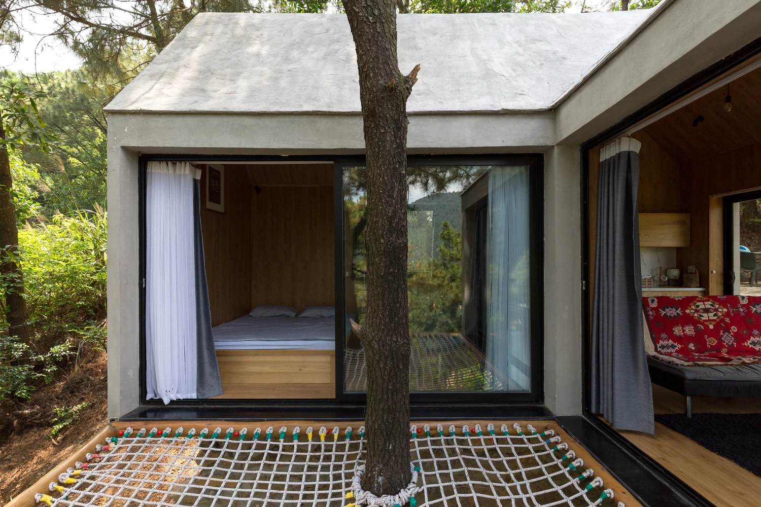 The 45sqm (484.4 sq ft) Forest House 02 is built in an L-shape to capitalize on the home's natural surroundings