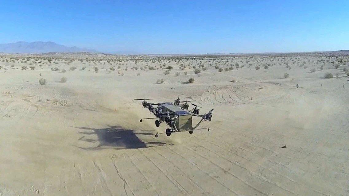 Snapshot from aerial footage of the aircraft in hover filmed by a quadcopter drone, which weighed approximately one thousandth of the weight of the Black Knight Transformer