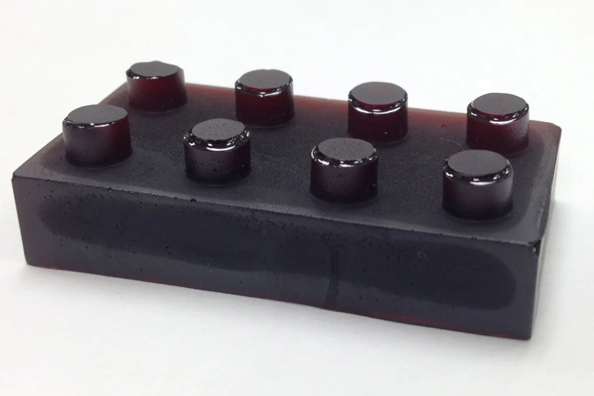 Sulfur-limonene polymer is a plastic made from citrus peel (here shown molded into the shape of a plastic building block) that can both detect and absorb mercury pollution