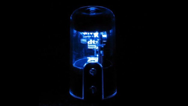 The tube-like glow from the blue light sitting inside the 18 carat gold-topped glass casing