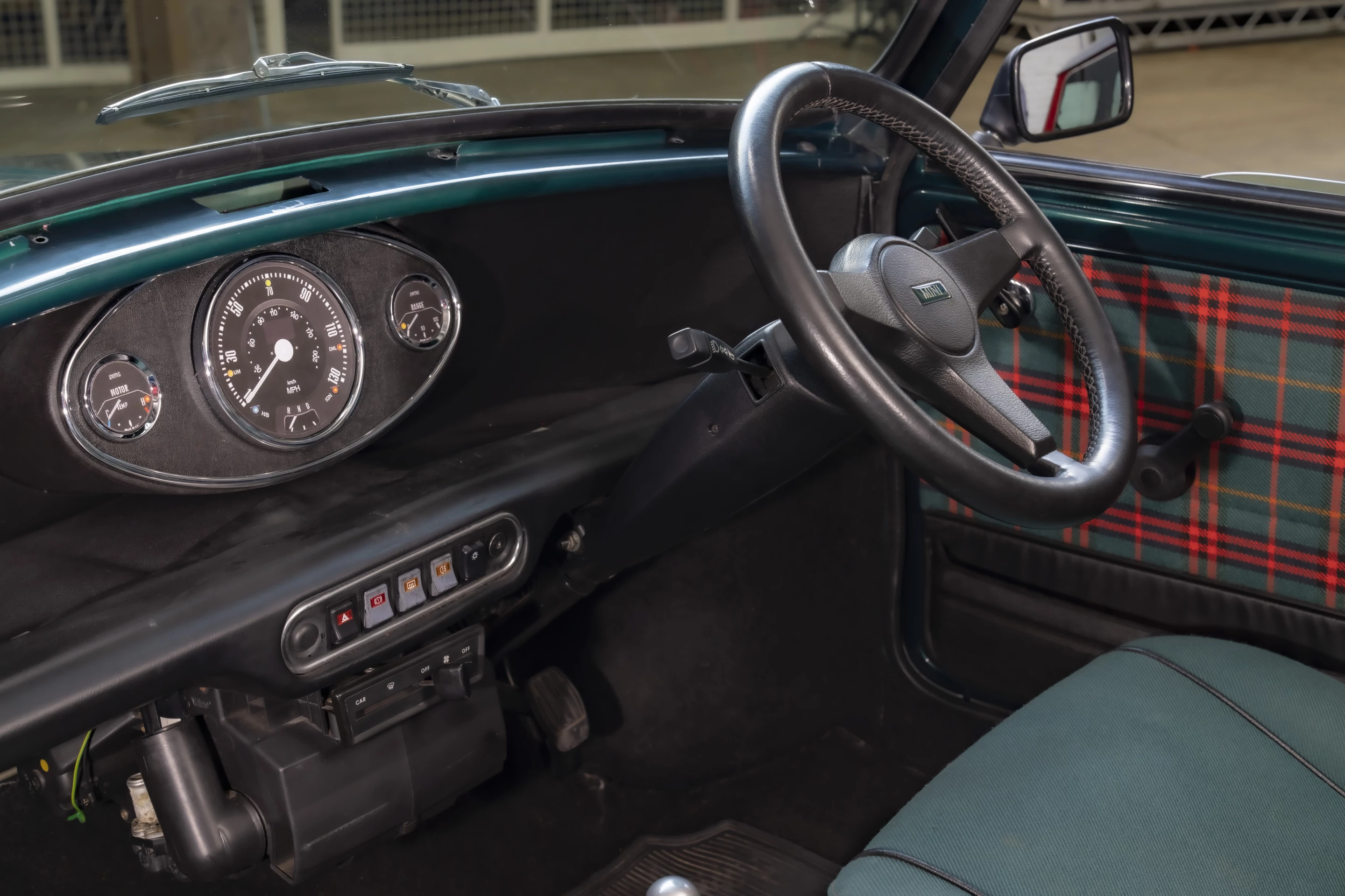 The original central instrument cluster looks the same but has been upgraded to show electric drive info