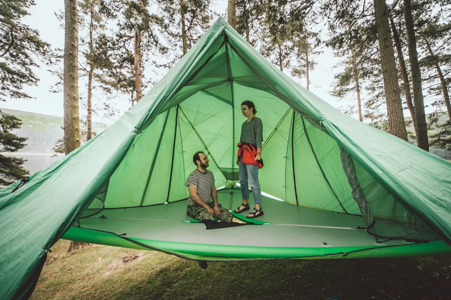 The Tentsile Universe's big, inflatable floor stretches across multiple trees or on the ground, providing a bed for up to five adults