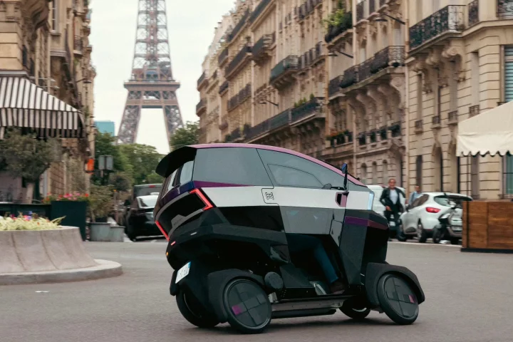 The AEMotion tilting electric vehicle navigating the streets of Paris, France, recently
