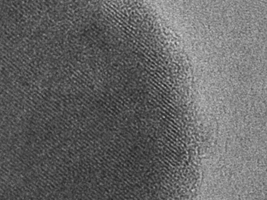 Image courtesy / Ceder LabScanning electron micrograph of a particle of the new battery material. Dark area indicates the inside of the particle surrounded by a lighter surface layer only five nanometer