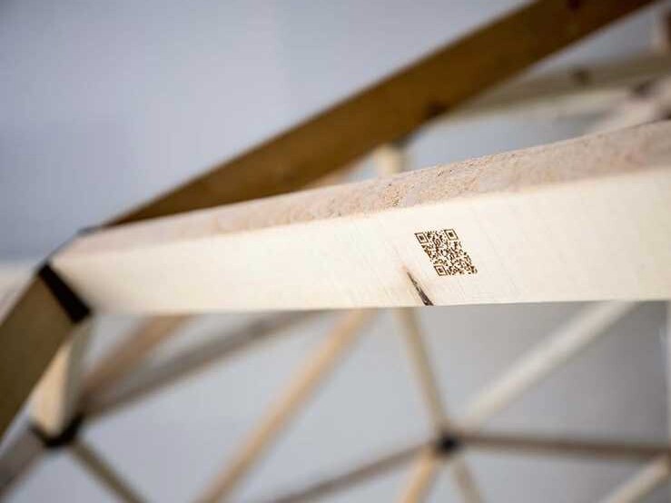 Each piece of wood is marked with a unique QR code