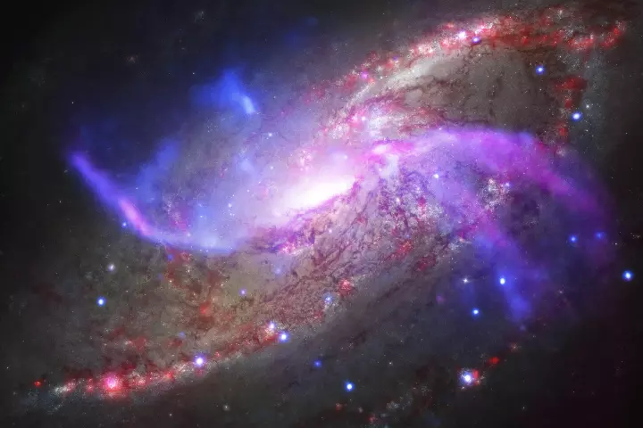 The spiral galaxy NGC 4258 is ejecting gas and high-energy particles in a spectacular display of galactic power (Image: NASA/CXC/JPL-Caltech/STScI/NSF/NRAO/VLA)