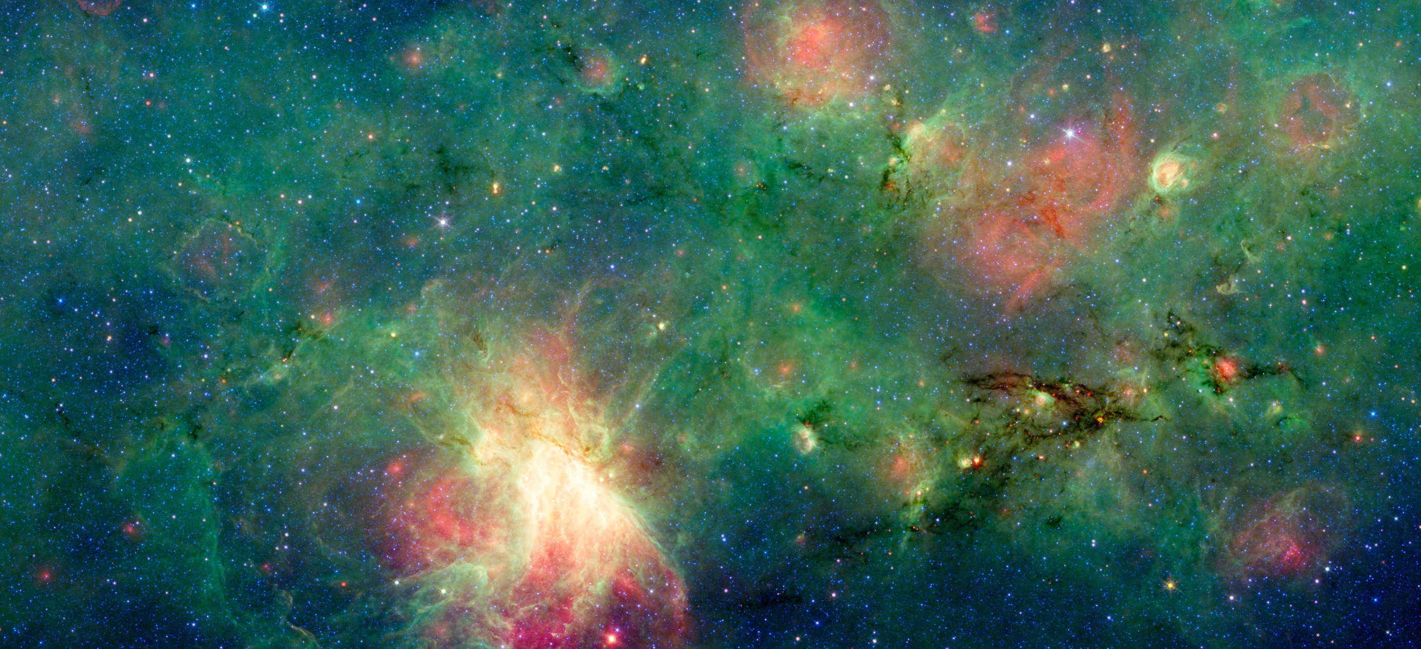 The glowing patch in the lower-left is the M17 nebula. Off to the right of the image is a dark star-forming cloud that resembles a dragon, which was invisible to visible light and only discovered in infrared.