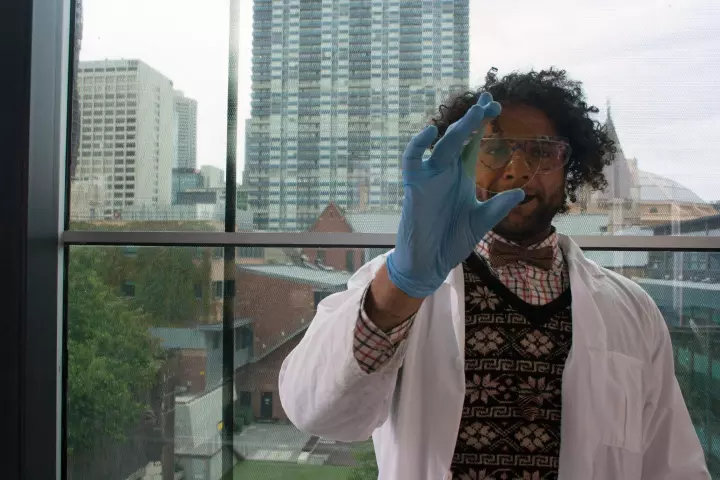 PhD student Mohammad Taha with a sample of coated glass