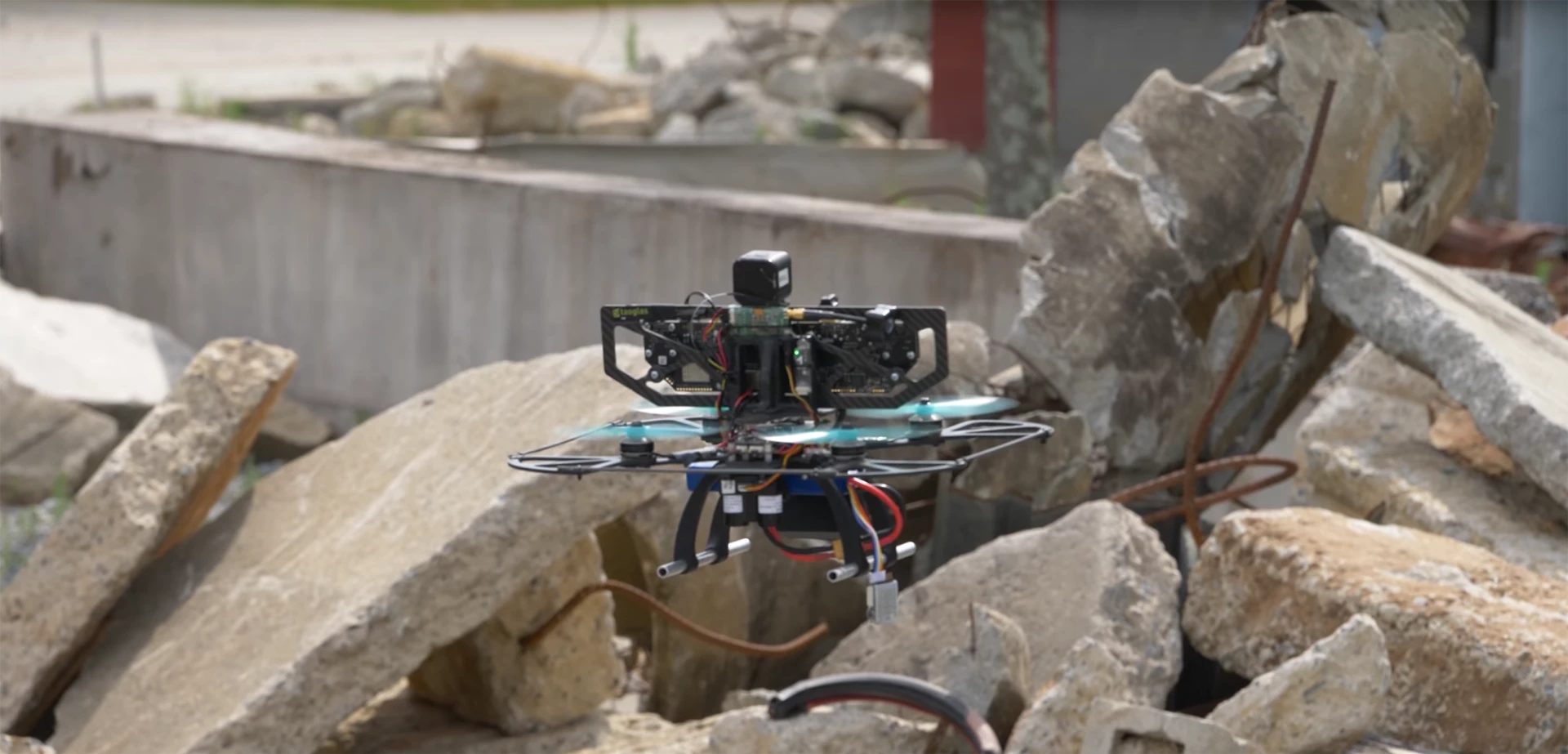 A DARPA FLA UAV investigates a collapsed building