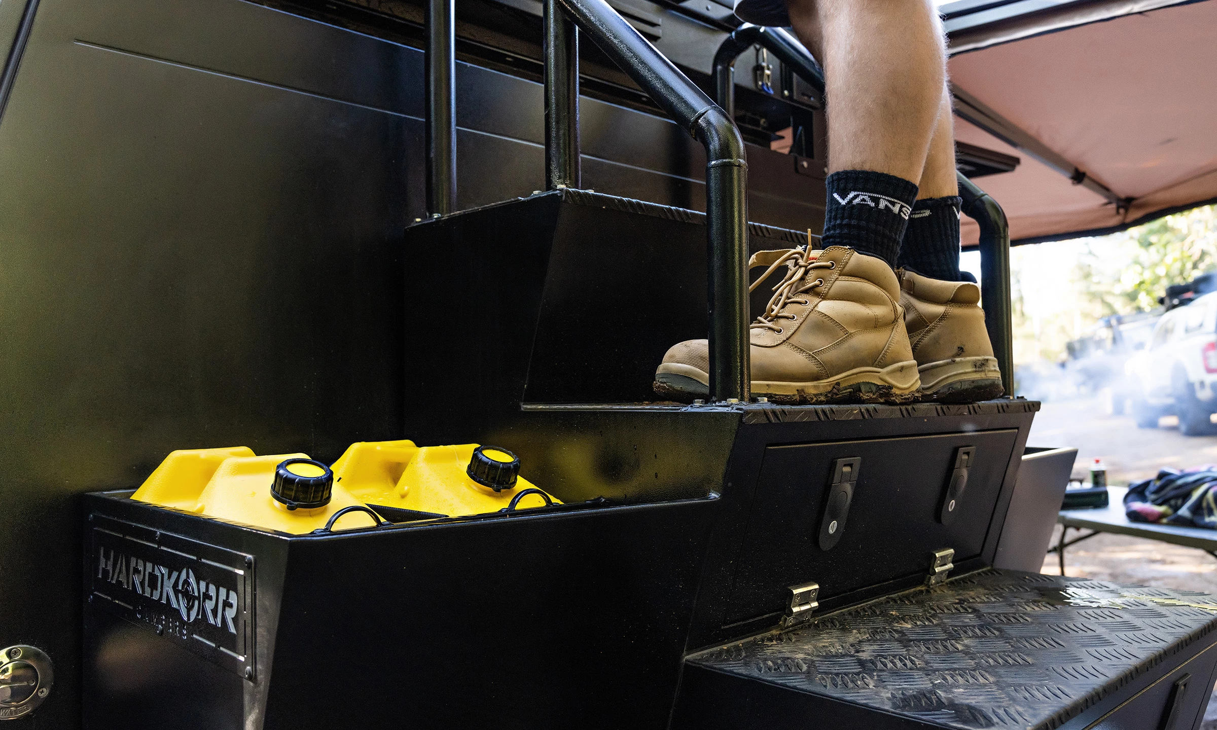 Jerry can holder next to the built-in staircase with integrated storage
