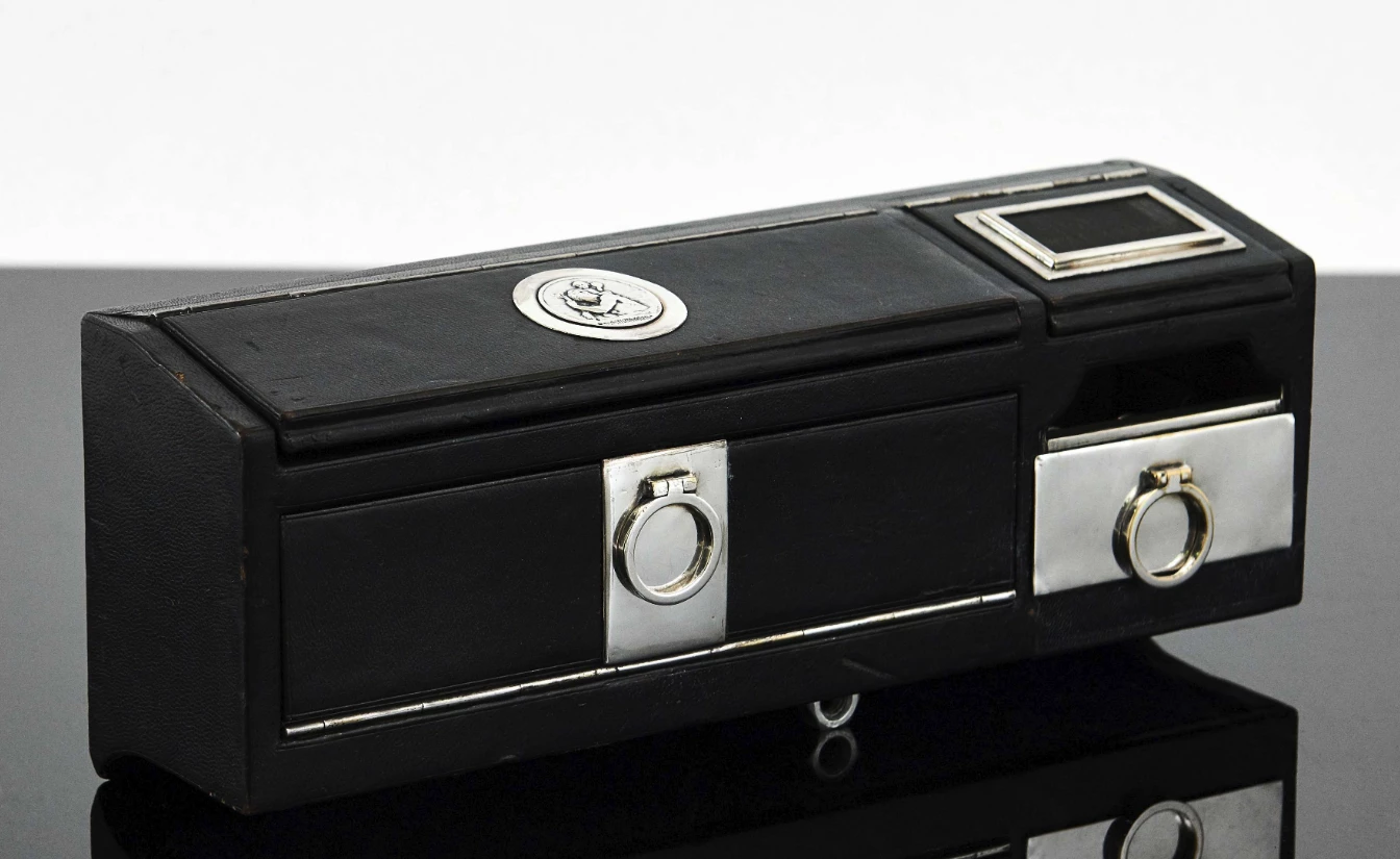 Auction Link: Artcurial | Estimate: €2,000 to €3,000 | A rare black leather motorcar tuxedo Travel Smoker Kit for Cars by Hermes Paris, c. 1930
