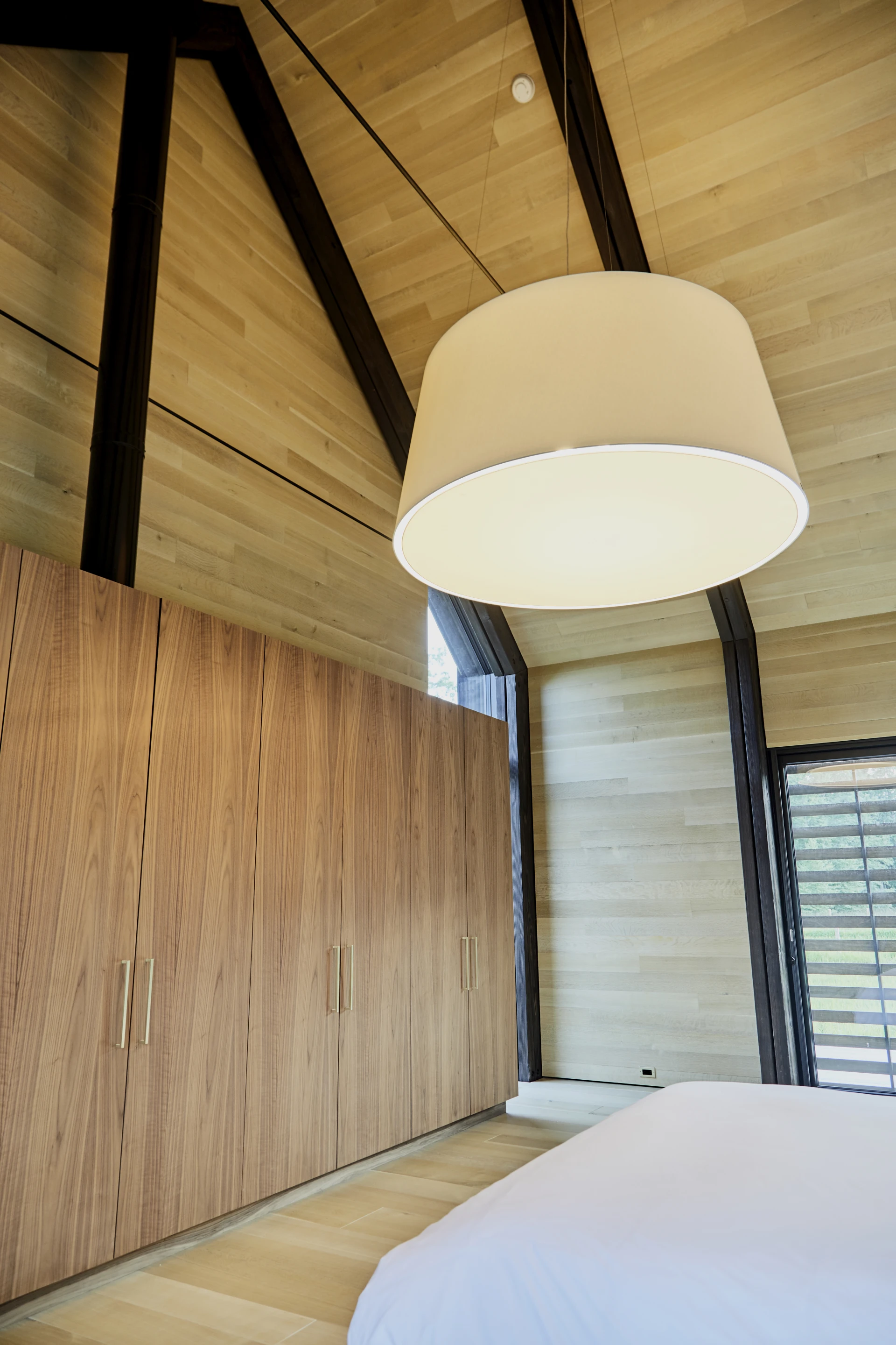 A newly finished dwelling in upstate New York takes careful cues from traditional farm buildings of the area, but makes every effort to afford it inhabitants the comfort of a modern home