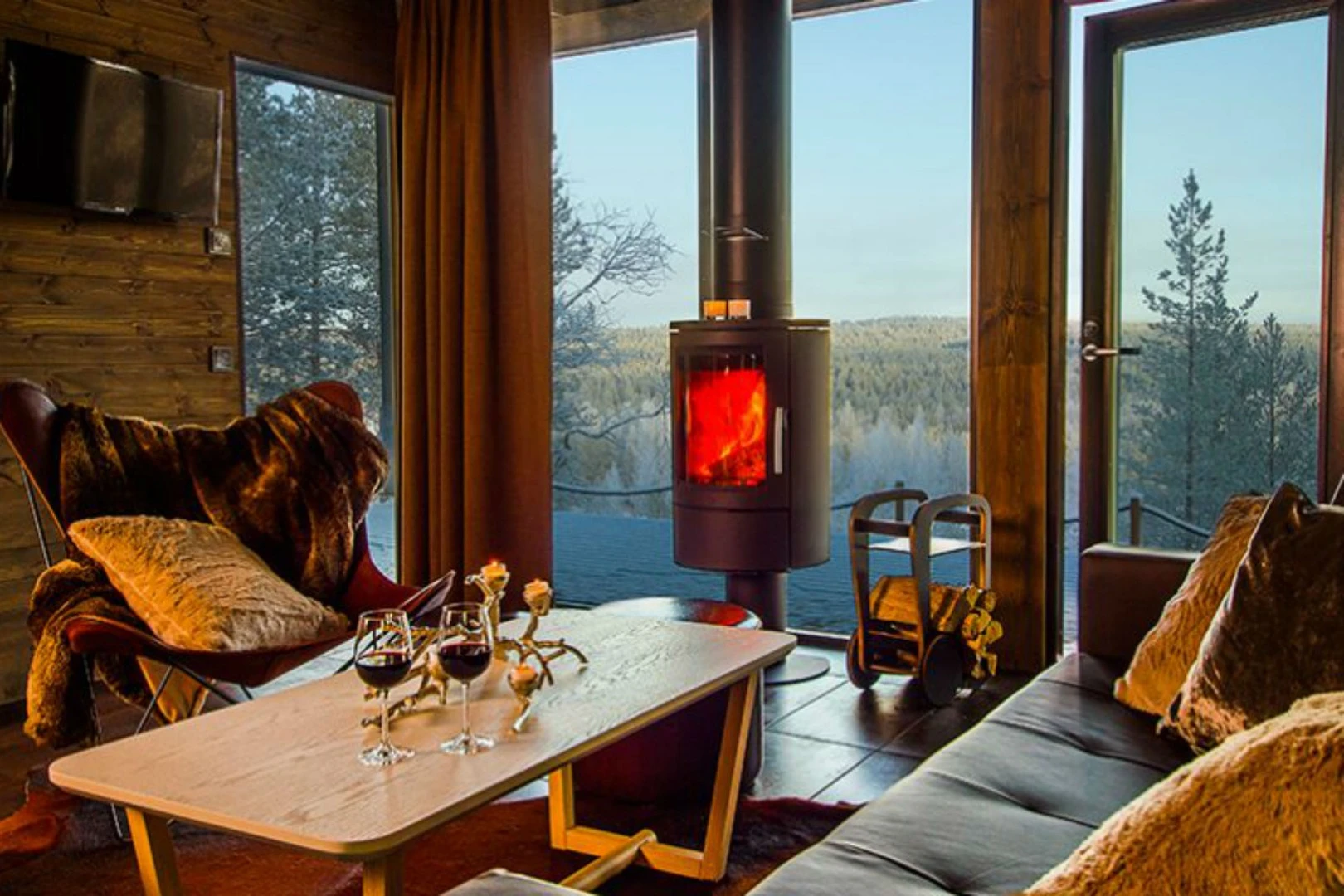 Arctic GlassHouses include a sumptuous lounge with a fireplace, two bedrooms, a kitchenette, a spacious deck area, a private sauna, and, of course, breathtaking views of the Lapland scenery