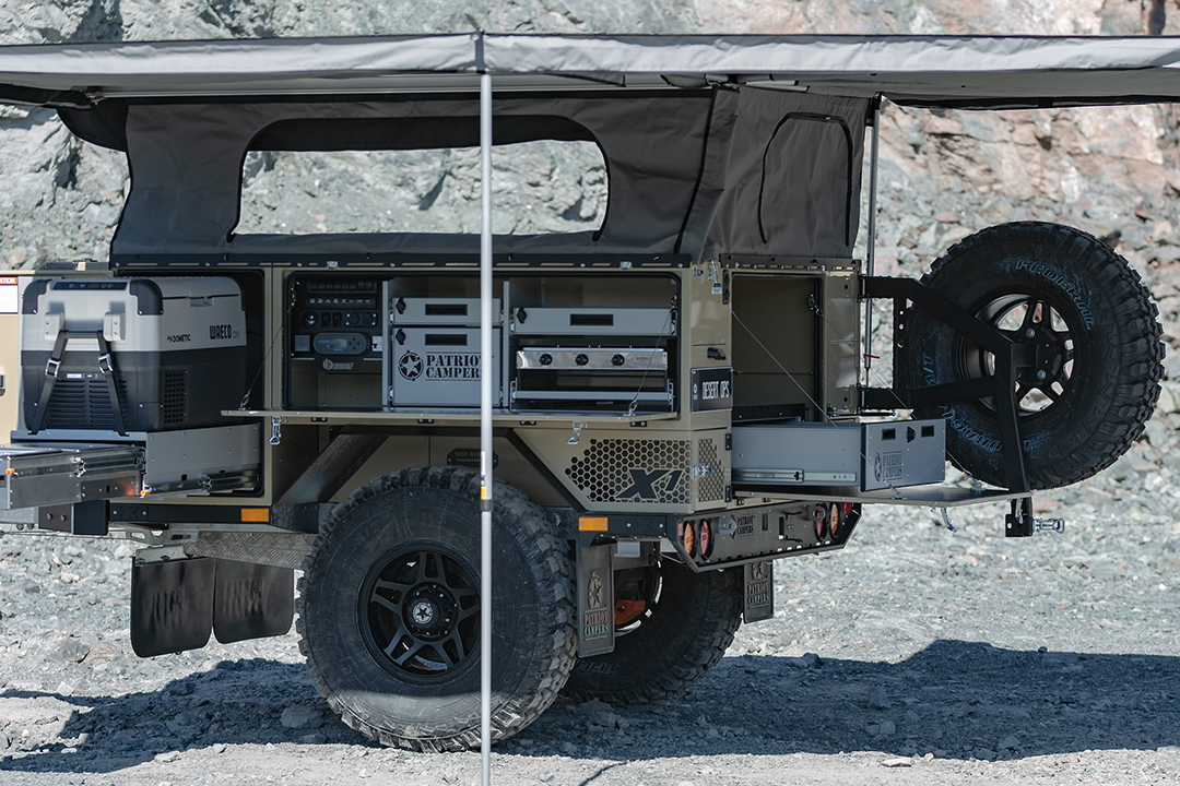 The X1-N comes standard with a slide-out kitchen with dual-burner stove, fridge slide with sink and plenty of storage space