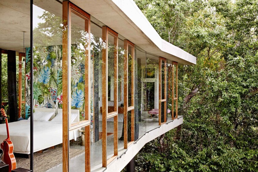 The Planchonella House sits on a 4,818-square-meter block (52,000-sq ft) on the edge of a nature park in the northern Australian coastal city of Cairns