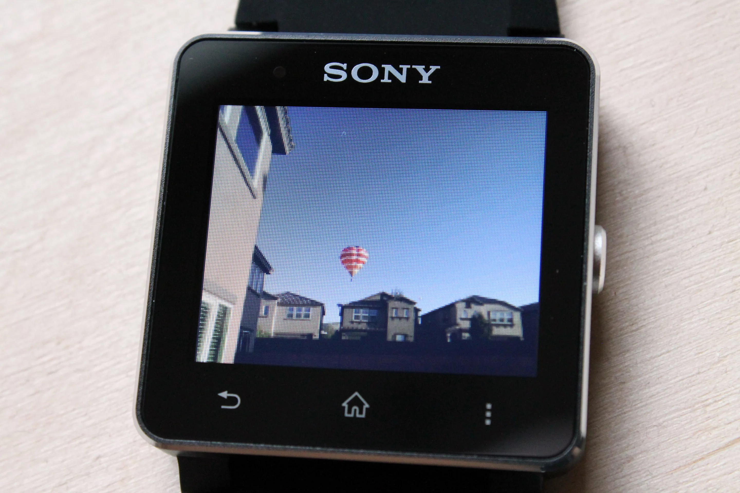 There's a plugin (downloaded from the Play Store) which lets you view your phone's image gallery on the watch