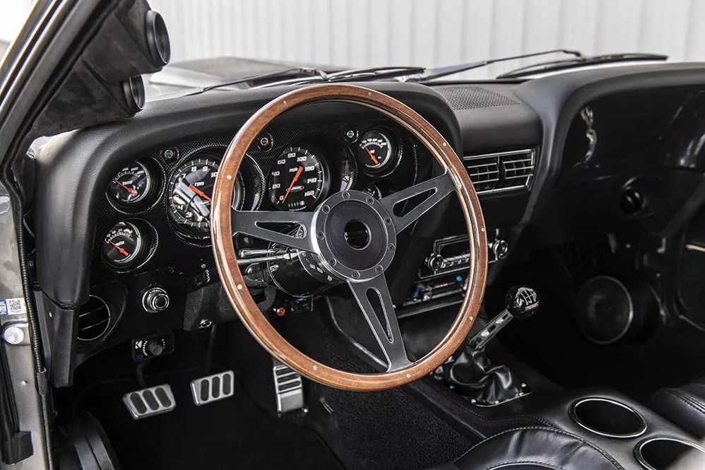 The Lacarra Aluminum steering wheel in the Mustang Mach 1 Hitman has been wood-wrapped
