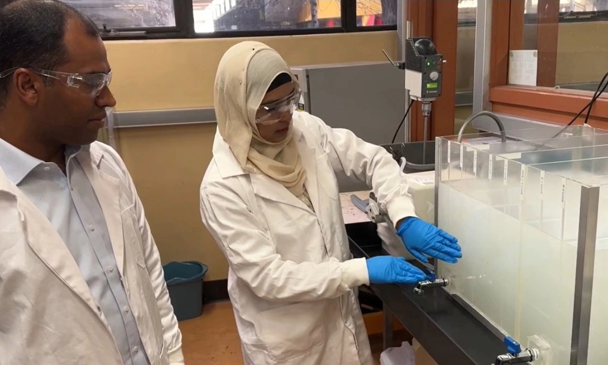 RMIT's Dr Biplob Pramanik (left) and Dr Nilufa Sultana (right) next to their advanced grease interceptor with multiple baffles to catch fat and grease