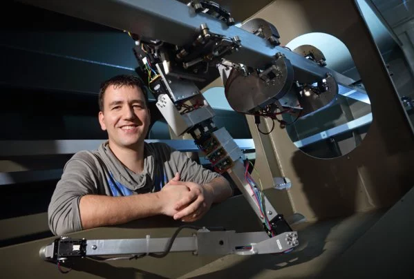 University of Twente researcher Dian Borgerink, with a manipulator arm that he developed for the RoboShip robot