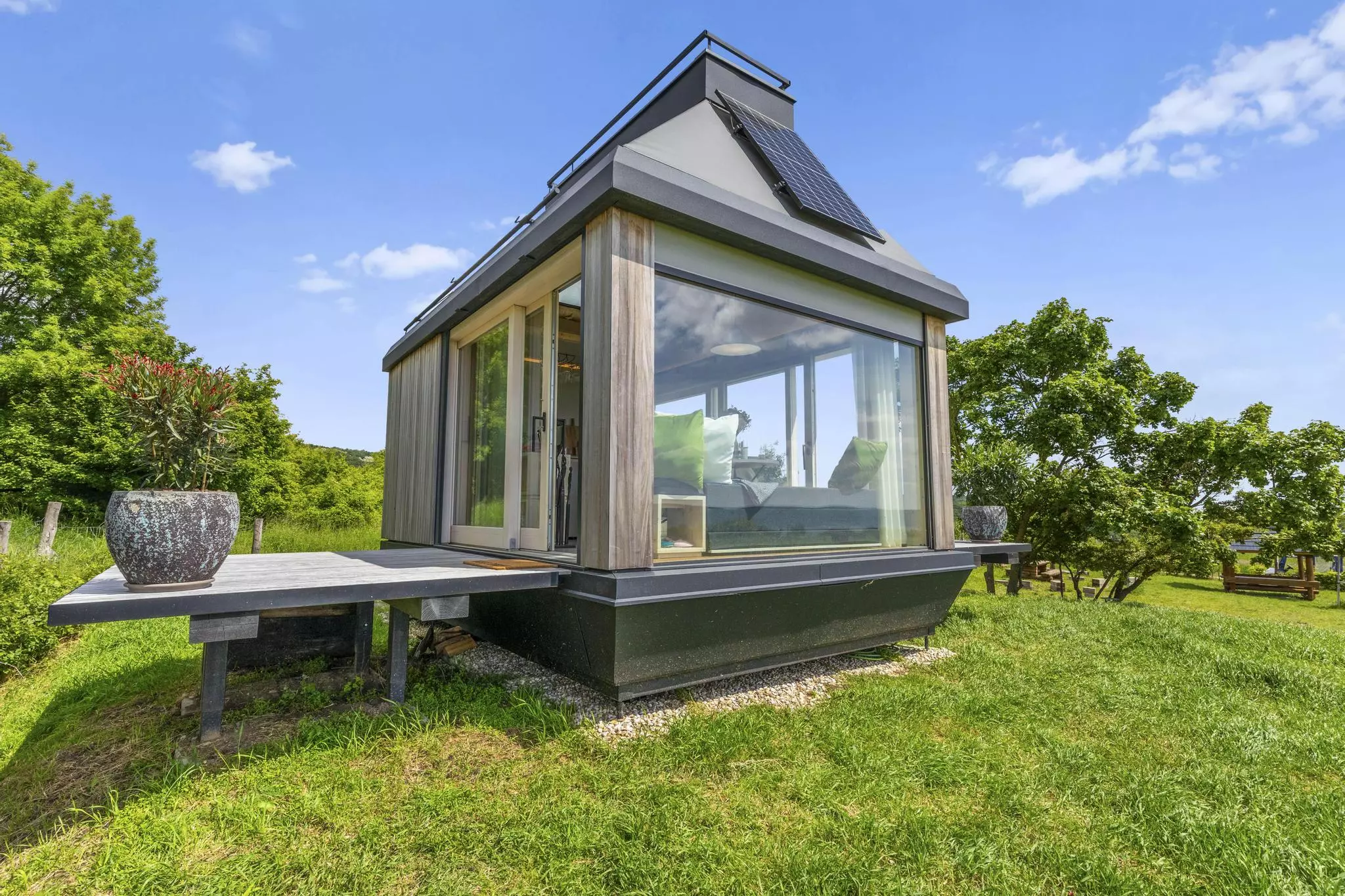 Cabin Devín includes fold-down terraces that, once lowered, reveal sliding glass walls