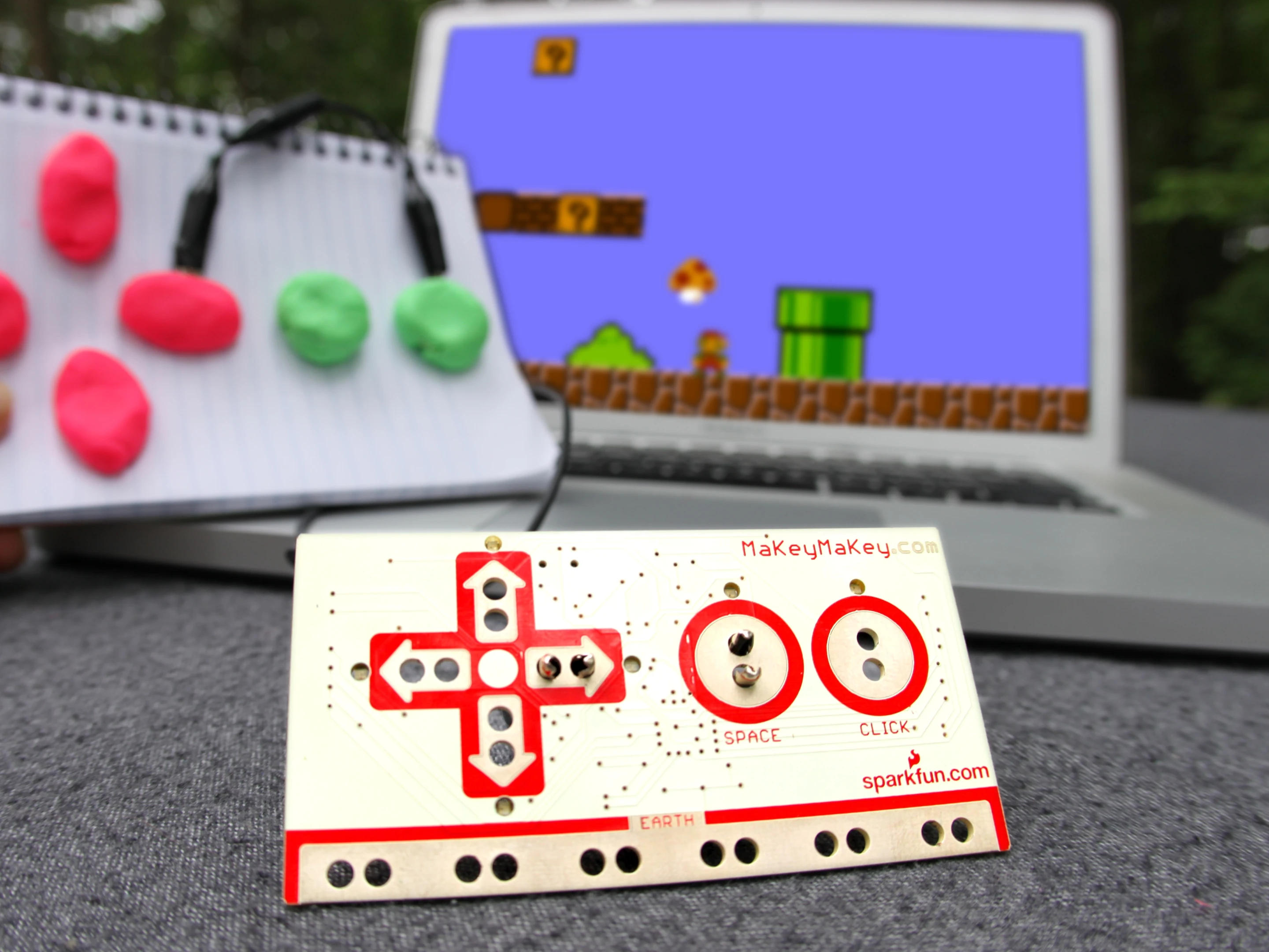 The Makey Makey board clipped to Play-Doh, which act as game controllers