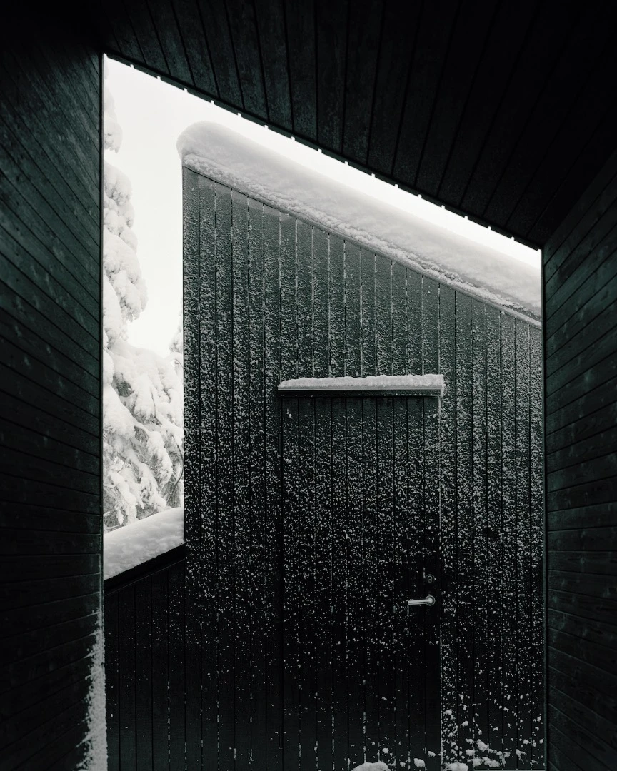 The exterior of the home is clad in black-stained ore pine and the interior is furnished in waxed poplar veneer