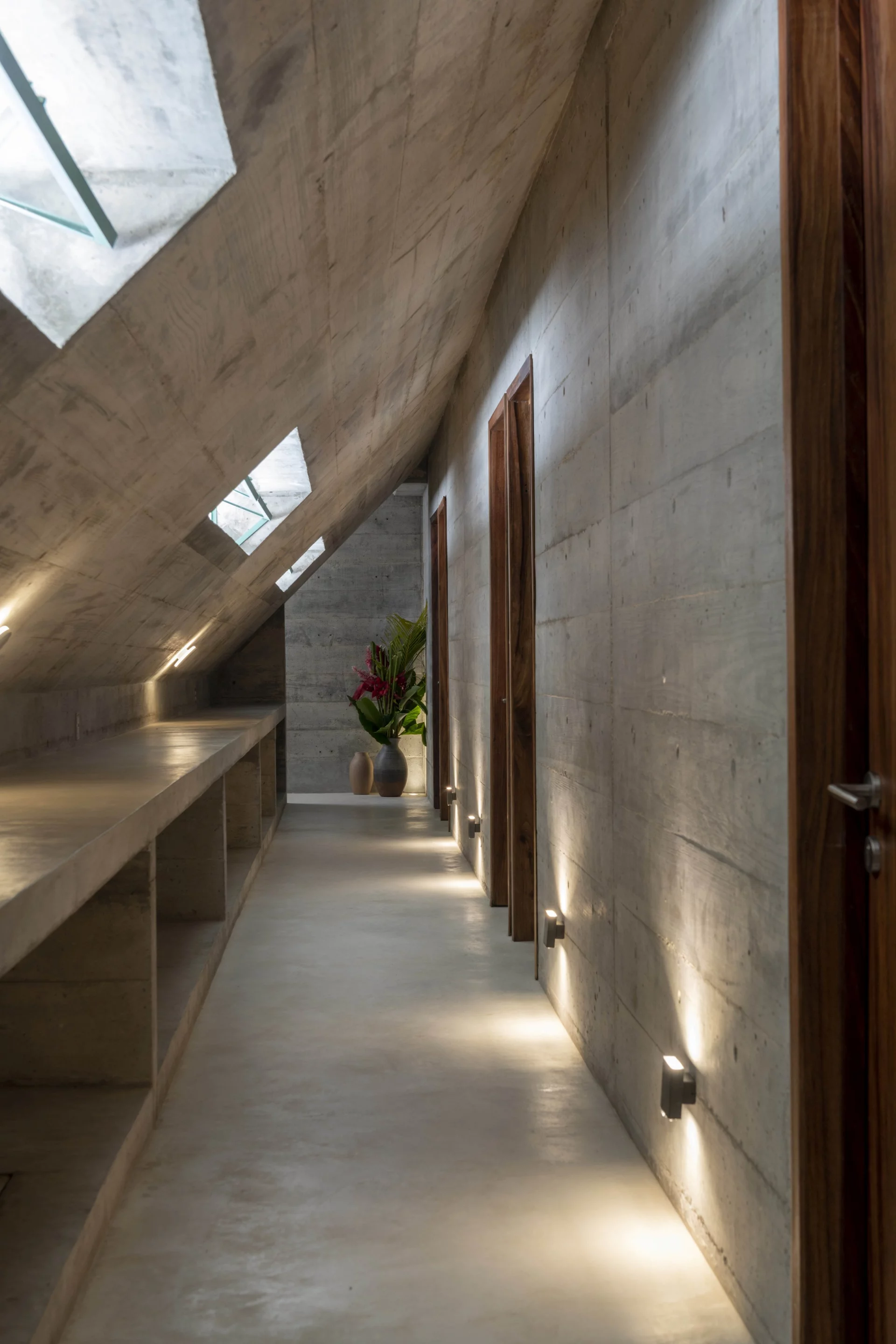Concrete corridor is filled with natural light and airflow