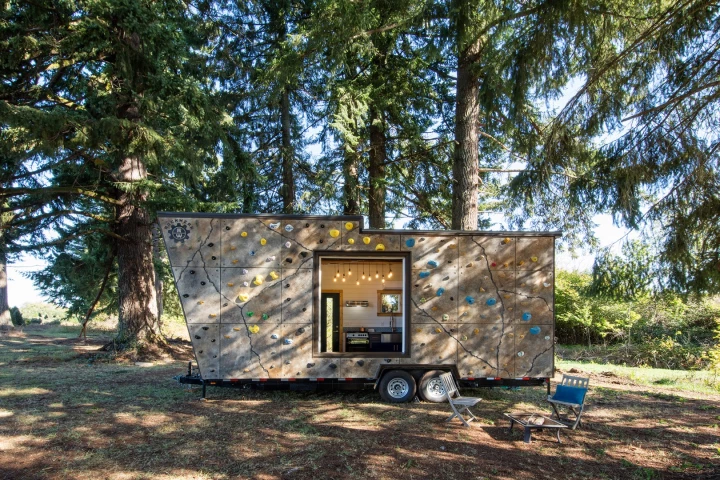 The Tiny Adventure Home features a rock climbing wall on its exterior