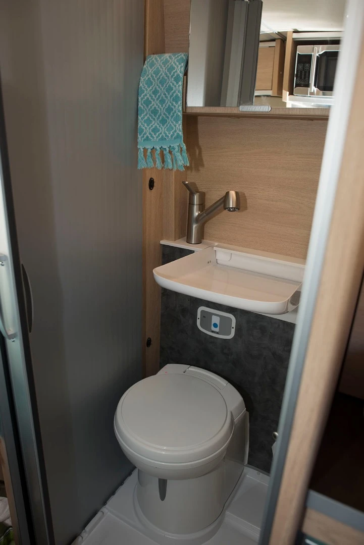 Hymer saves space in the bathroom with a flip-down sink and swivel toilet