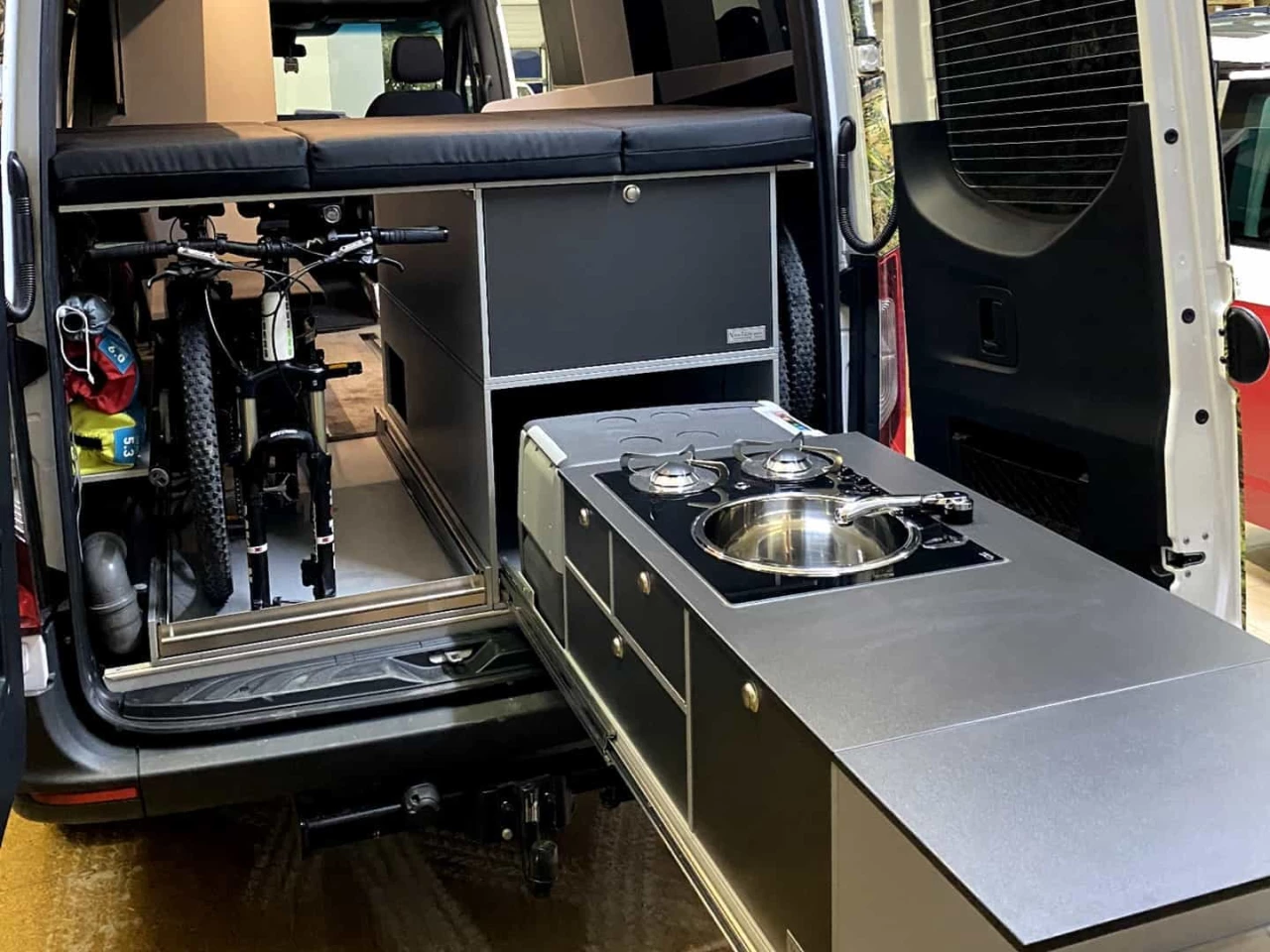 The rear slide-out kitchen is redundant in a van that also has a similarly equipped indoor kitchen but could serve as the single kitchen solution, freeing up space inside the sliding door