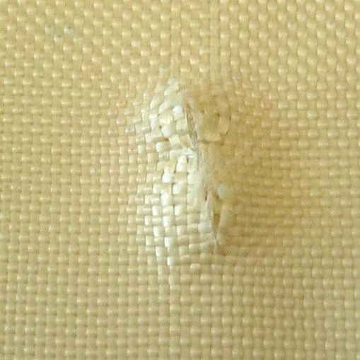 The back of Kevlar fabric after being stabbed with a knife