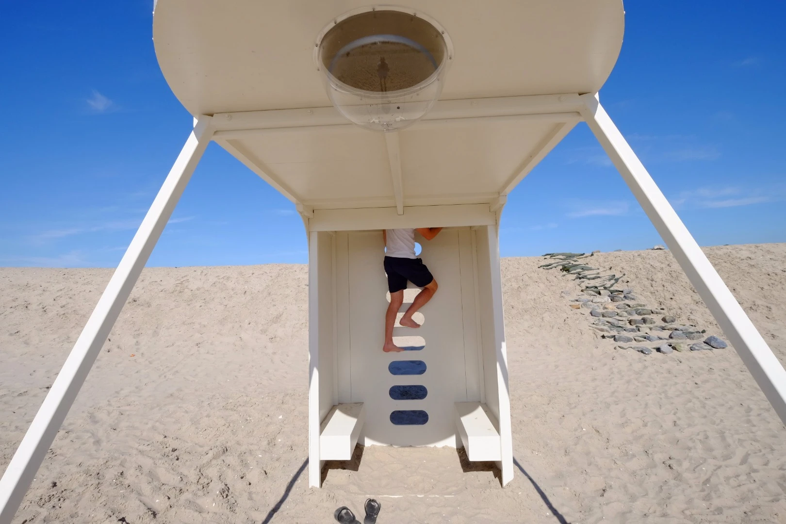 Residents enter "Upside down you turn me" via a ladder, with a space to sit at the bottom