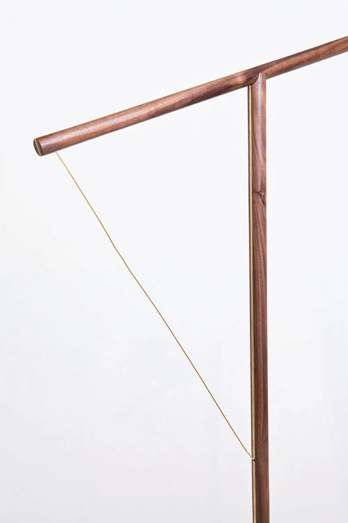 One wooden rood containing an LED light source is balanced in a T formation across another upright wooden rood, anchored with the electrical wire running between them (Photo: Mieke Meijer)