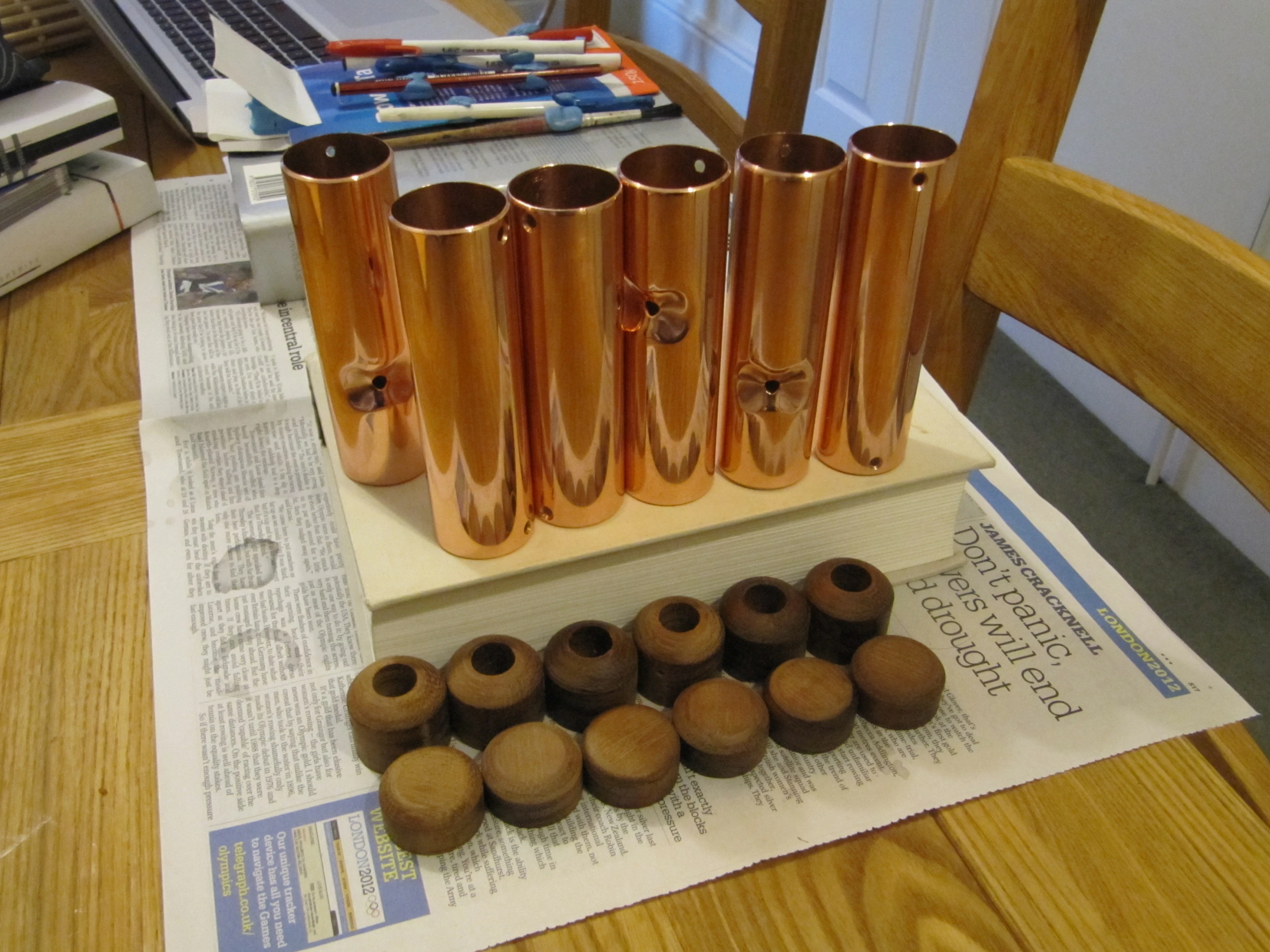 The optical sensor sits at the bottom of a saddle-shaped guide in polished copper tube stopped with wooden ends