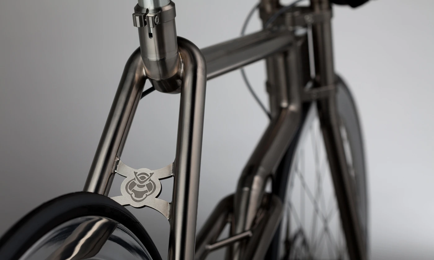Instead of simply bending the titanium tubes to create curves, those curves are made by incrementally TiG-welding together a series of fan-shaped pieces of titanium