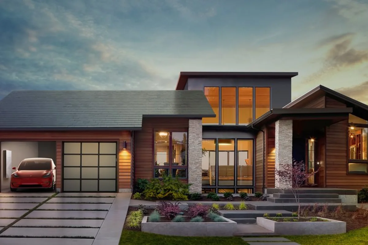 Tesla envisions a house with solar roof tiles and a powerwall and electric vehicle in the garage